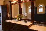 The Colorado Room en-suite bathroom with double vanity & shower/tub. 